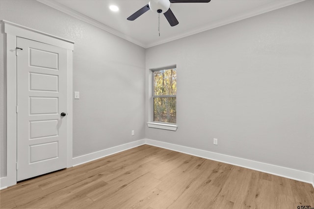 spare room featuring light hardwood / wood-style floors, ceiling fan, and crown molding