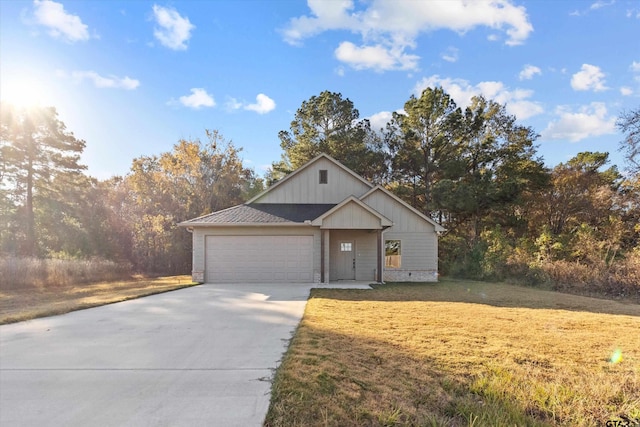 view of front of home with a garage and a front lawn