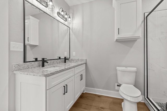 bathroom featuring a shower, hardwood / wood-style floors, vanity, and toilet