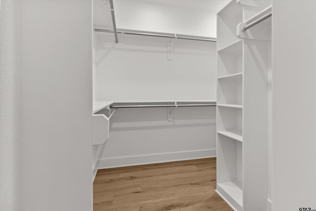 walk in closet featuring hardwood / wood-style floors