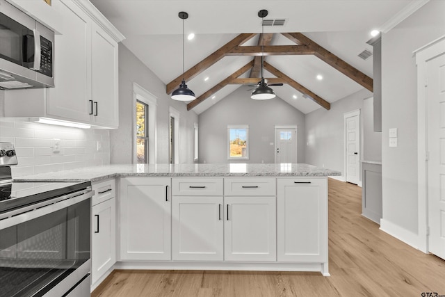 kitchen with pendant lighting, lofted ceiling with beams, light wood-type flooring, appliances with stainless steel finishes, and white cabinetry