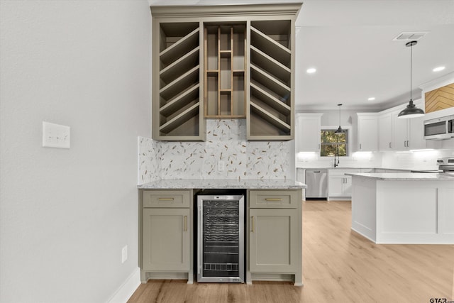 kitchen with wine cooler, light hardwood / wood-style flooring, stainless steel dishwasher, decorative backsplash, and decorative light fixtures