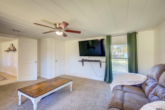 carpeted living room with ceiling fan