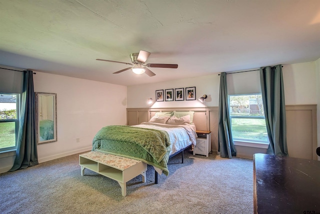 bedroom with carpet floors, multiple windows, and ceiling fan