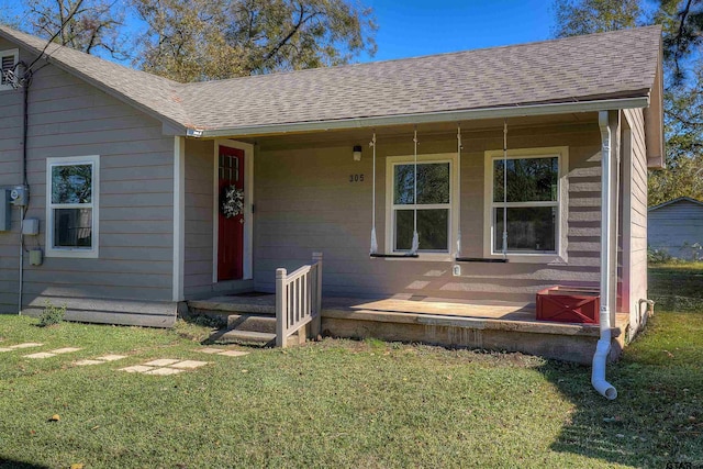 view of front of property featuring covered porch and a front yard