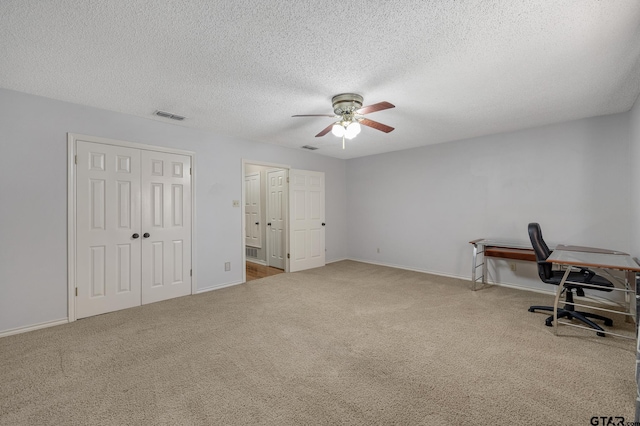 office space featuring ceiling fan and a textured ceiling