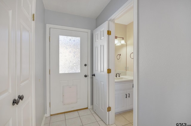 entryway with light tile patterned flooring and sink