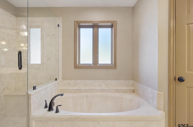 bathroom featuring separate shower and tub