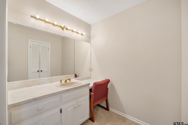 bathroom featuring vanity and a textured ceiling