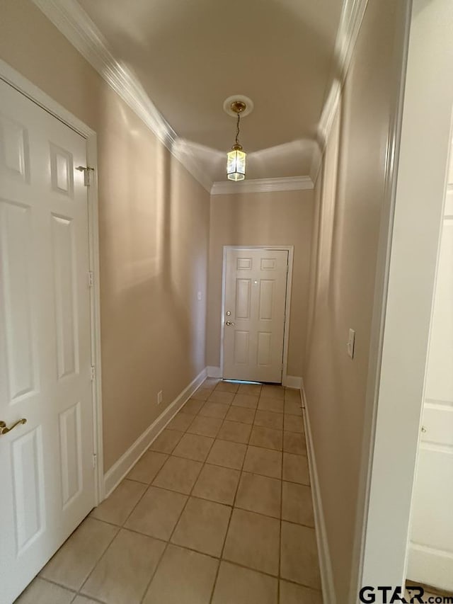 doorway featuring light tile patterned flooring and ornamental molding