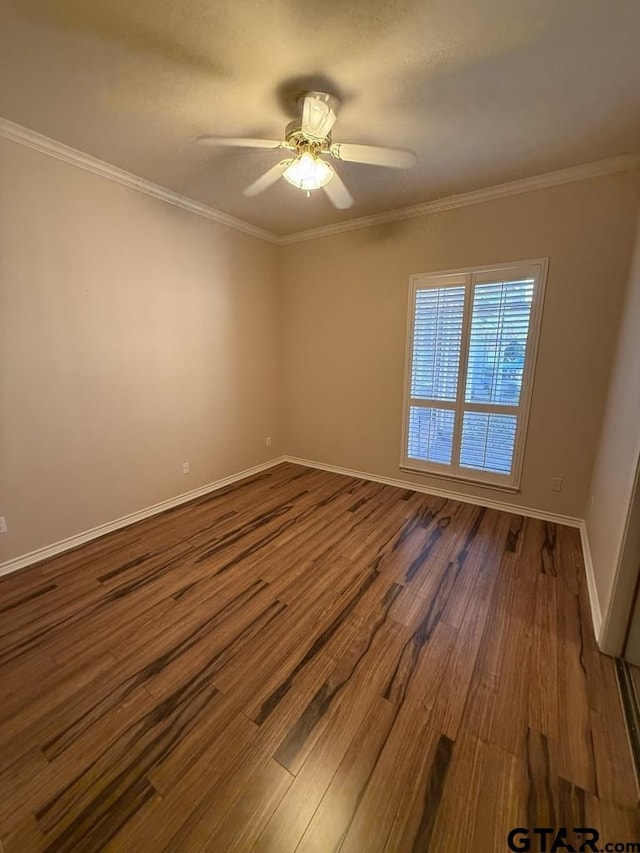 empty room featuring hardwood / wood-style flooring, ceiling fan, and ornamental molding