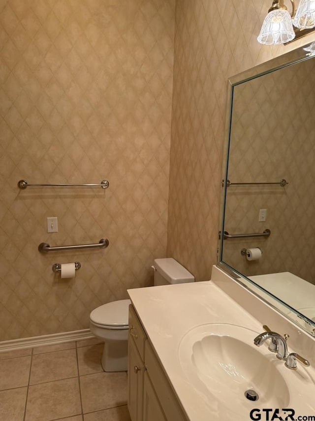 bathroom featuring vanity, tile patterned floors, and toilet