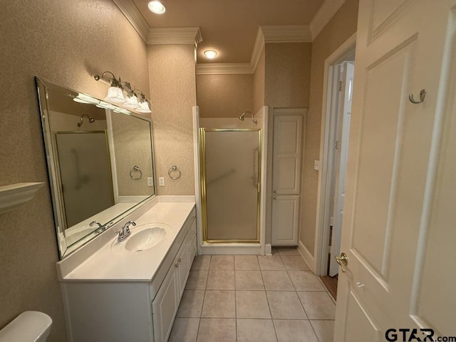 bathroom featuring vanity, crown molding, a shower with door, and tile patterned floors