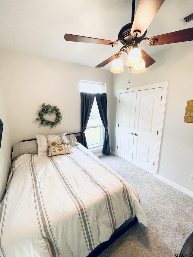 bedroom featuring a closet, ceiling fan, and carpet