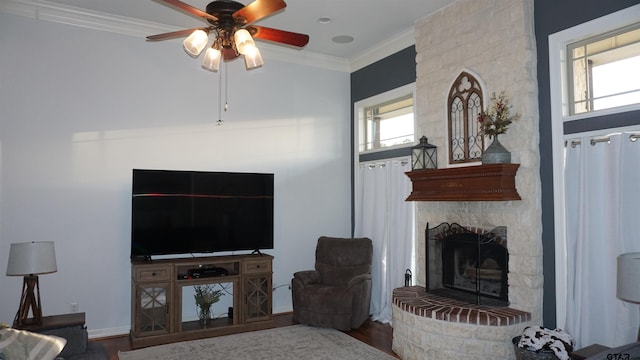 living room with hardwood / wood-style floors, ornamental molding, and a fireplace