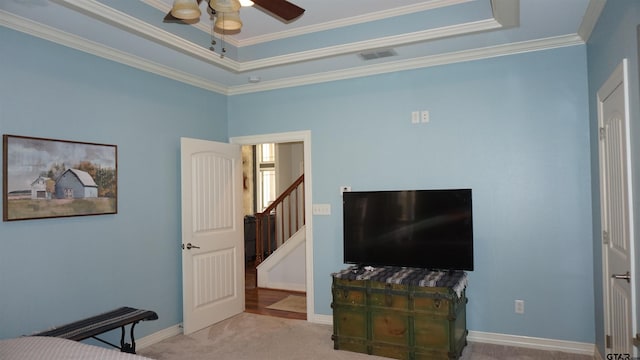 bedroom featuring crown molding, light colored carpet, and ceiling fan