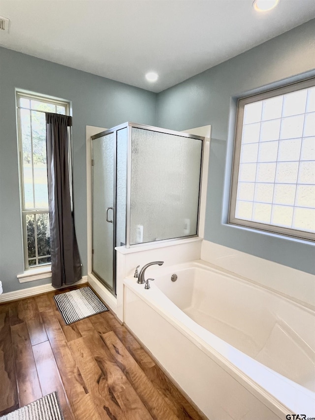102 Acr 3192, Frankston, TX 75763 - bathroom with a garden tub, wood finished floors, a stall shower, baseboards, and recessed lighting