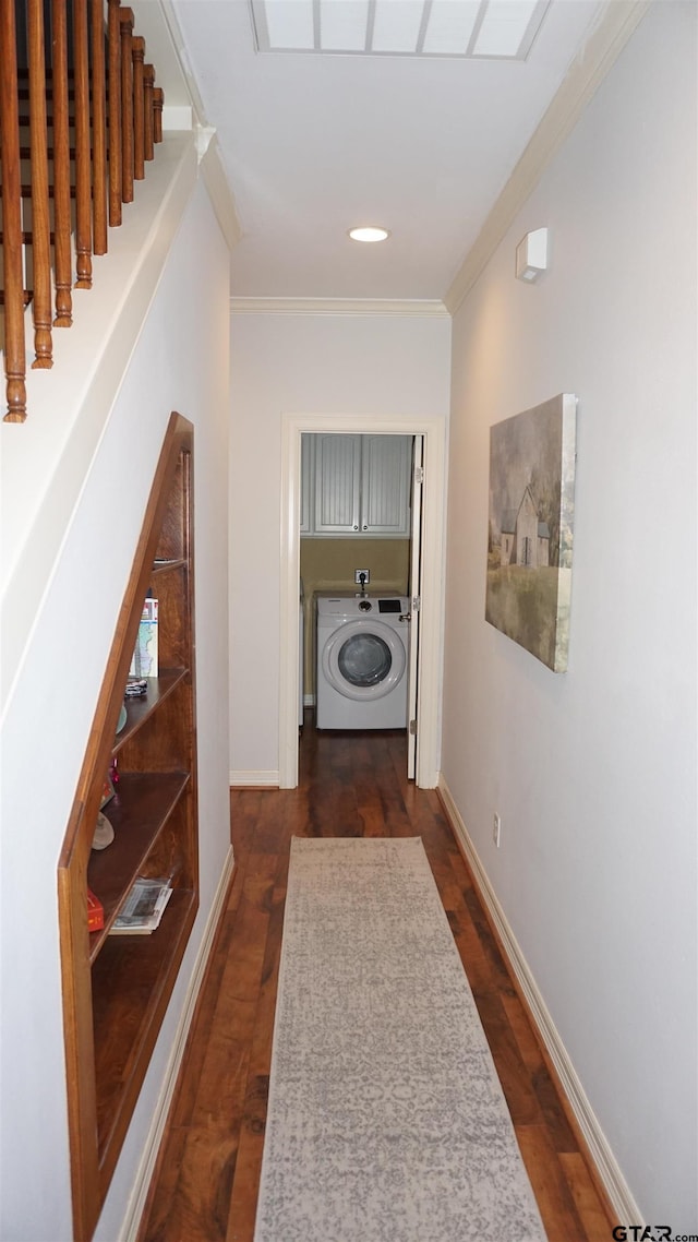 hall with washer / clothes dryer, dark hardwood / wood-style floors, and ornamental molding