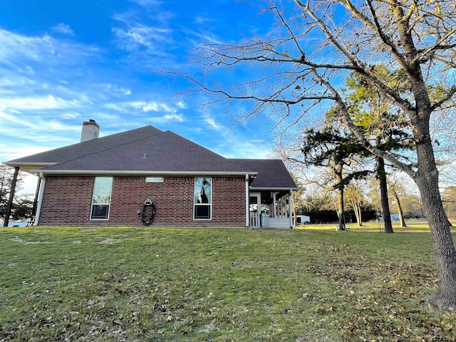 102 Acr 3192, Frankston, TX 75763 - rear view of house featuring a yard, brick siding, and a chimney