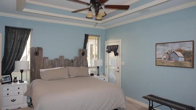 bedroom with ceiling fan, light colored carpet, a tray ceiling, and crown molding