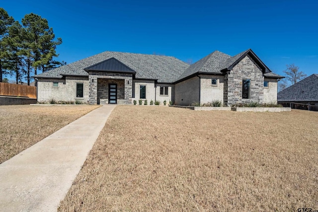 view of front of property with fence and a front lawn