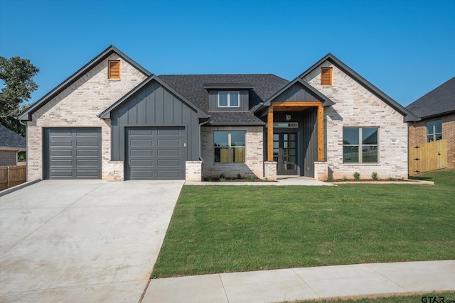 view of front of property featuring a garage and a front yard