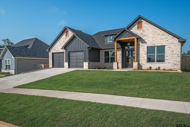 view of front of property featuring french doors, a front lawn, and a garage