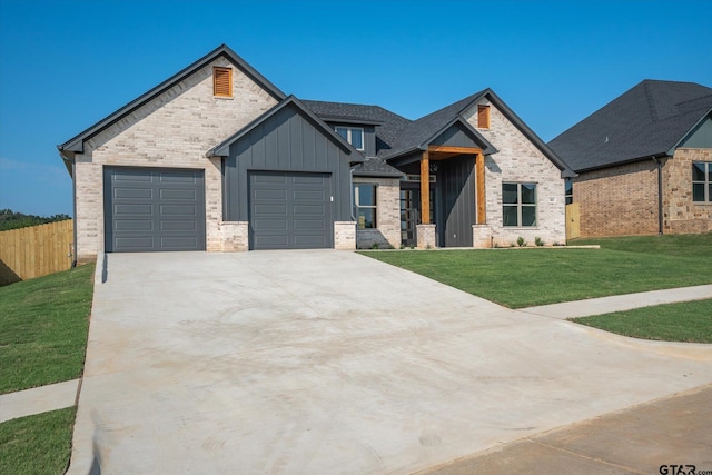 craftsman inspired home with a garage and a front lawn