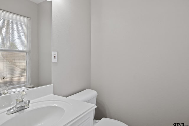 half bath featuring toilet and vanity
