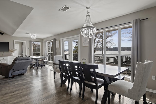 dining room featuring an inviting chandelier, visible vents, dark wood finished floors, and french doors