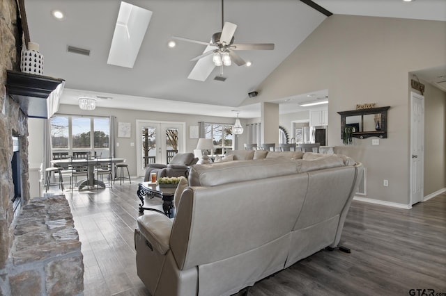 living room with french doors, dark wood-type flooring, plenty of natural light, and visible vents