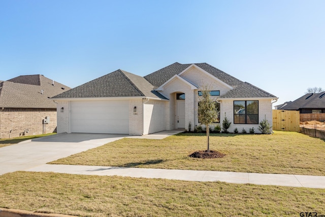 view of front of property with a garage and a front lawn