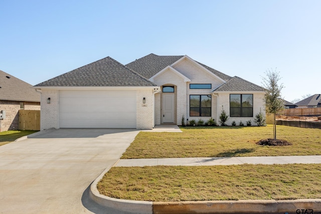 view of front of house with a front yard and a garage