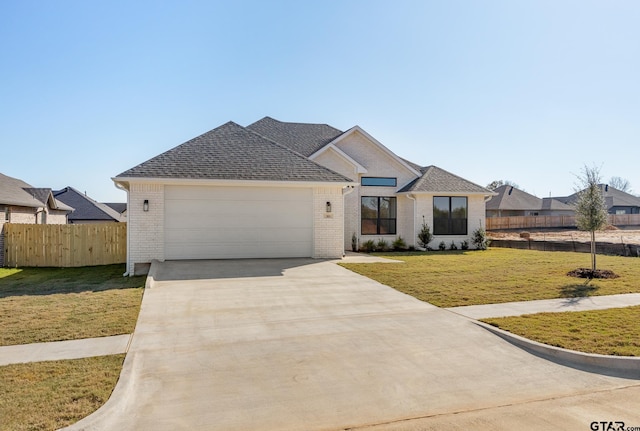 view of front of property featuring a garage and a front yard