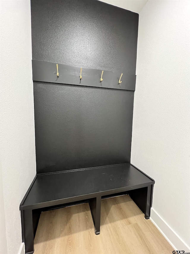 mudroom featuring wood finished floors and baseboards