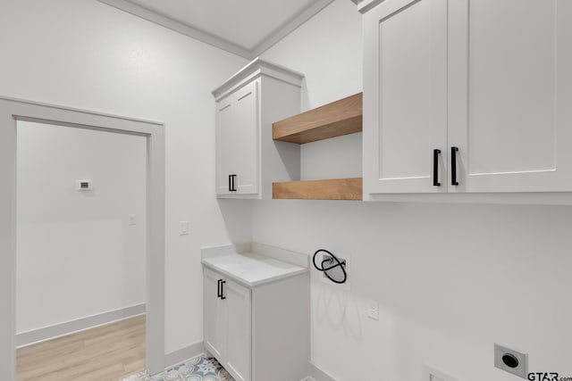 laundry area featuring hookup for an electric dryer and cabinets