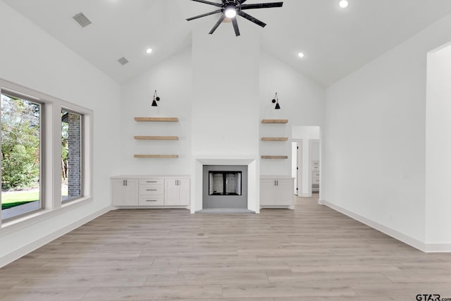 unfurnished living room with ceiling fan, high vaulted ceiling, and light hardwood / wood-style flooring