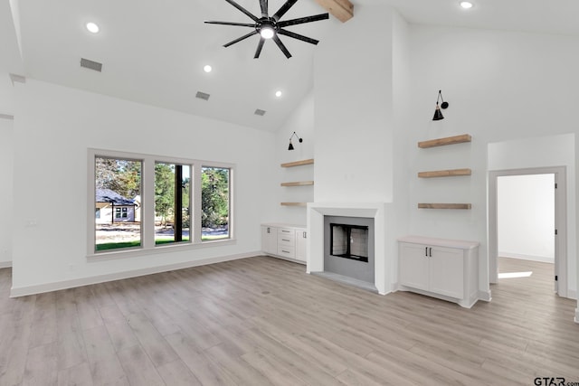 unfurnished living room with ceiling fan, high vaulted ceiling, beam ceiling, and light hardwood / wood-style flooring