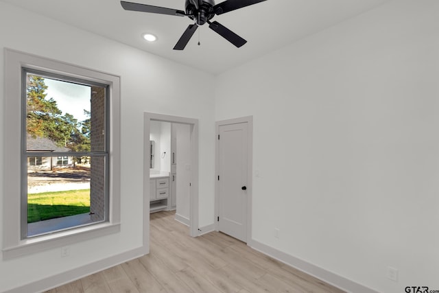 empty room featuring ceiling fan and light hardwood / wood-style flooring