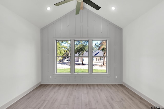 unfurnished room with ceiling fan, light hardwood / wood-style flooring, and lofted ceiling