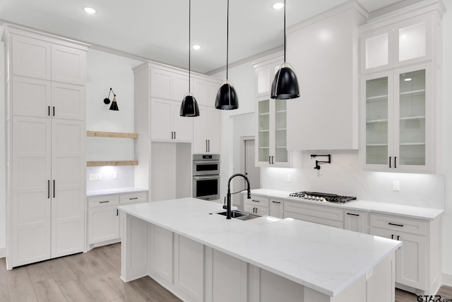 kitchen with white cabinetry, sink, pendant lighting, and appliances with stainless steel finishes