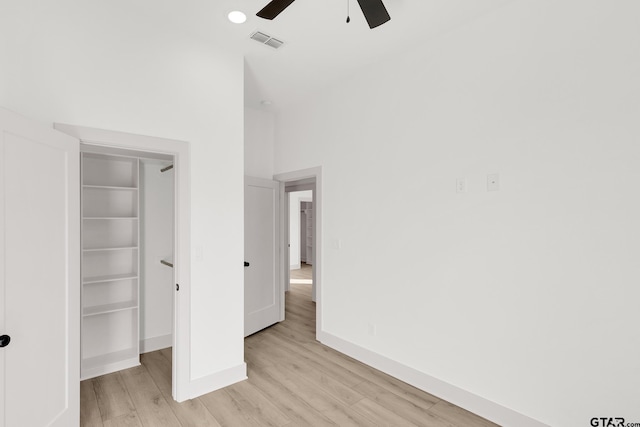 unfurnished bedroom with ceiling fan, a closet, and light hardwood / wood-style flooring