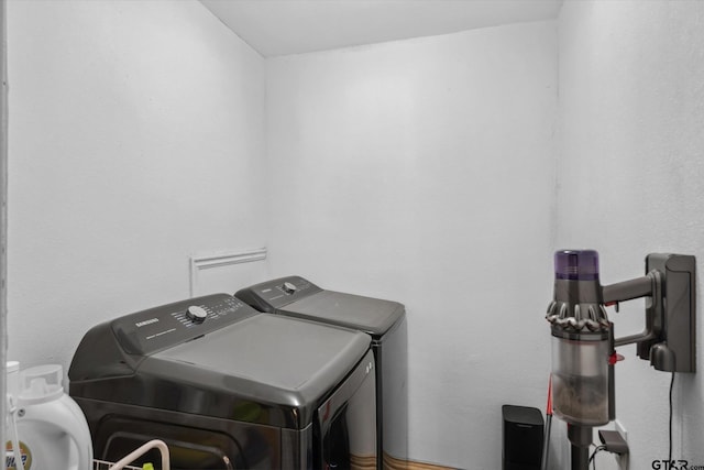 clothes washing area with laundry area and washer and clothes dryer