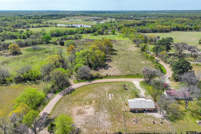 birds eye view of property featuring a water view and a rural view