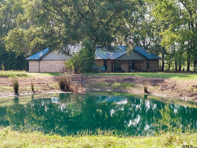 view of swimming pool featuring a water view