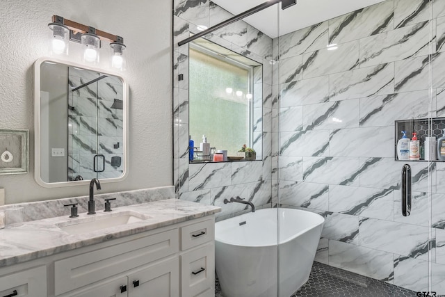 bathroom featuring vanity and independent shower and bath