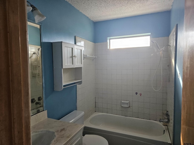 bathroom featuring vanity, a textured ceiling, toilet, and bathing tub / shower combination