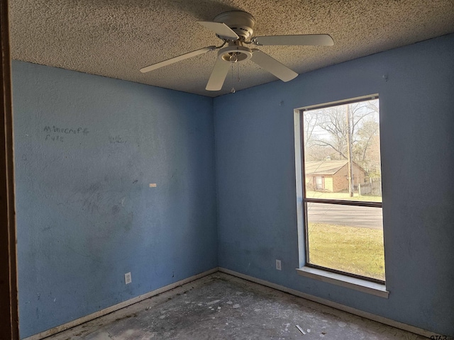 spare room with a ceiling fan and a textured ceiling