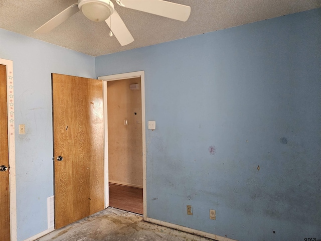 unfurnished bedroom featuring ceiling fan, unfinished concrete floors, and a textured ceiling