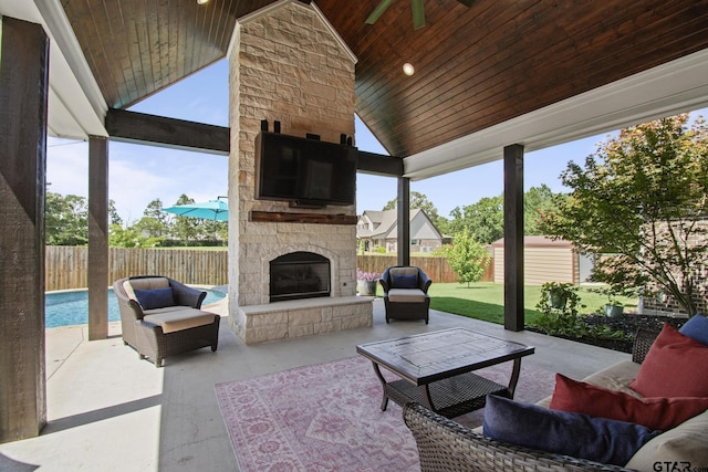 109 Nathan, Chandler, TX 75758 - fenced backyard featuring a patio area and an outdoor living space with a fireplace